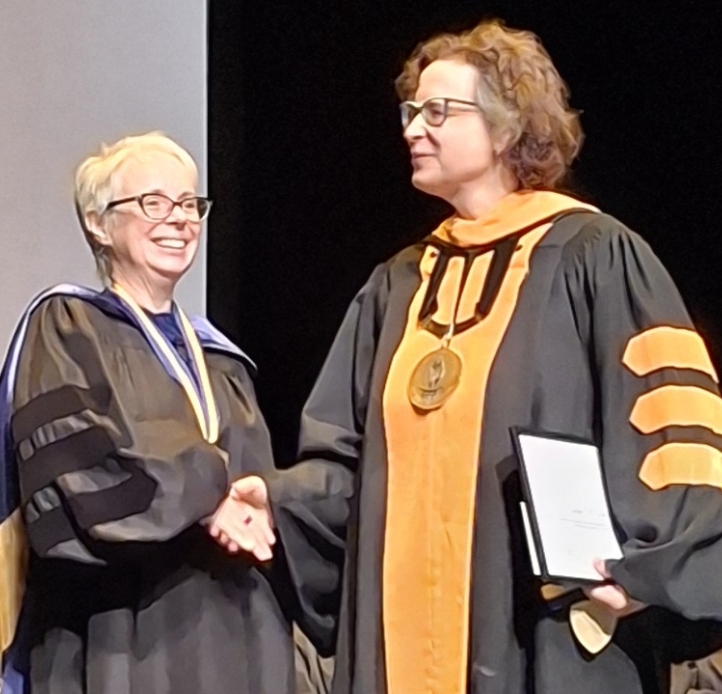 Chesterton reveiving her award from President Burris